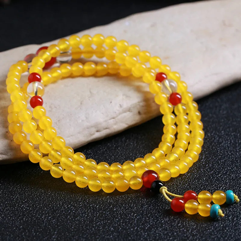 108-bead polished agate and crystal necklace with geometric beads and matching canary stone bracelet on display