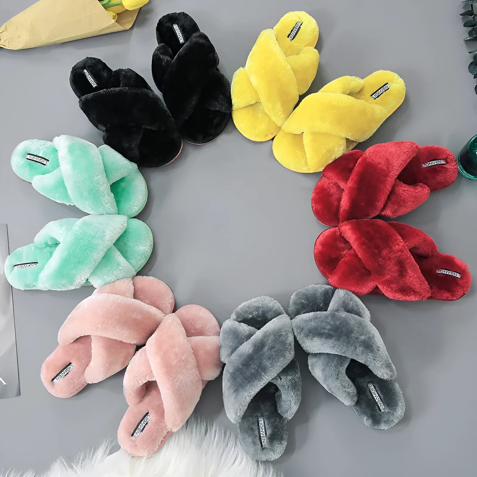 Women's black cross open-toe fur slippers with a textured non-slip rubber sole.
