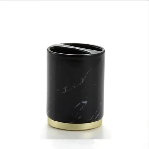 Four-piece ceramic bathroom set with bright glaze finish including bottle, cup, toothbrush holder, and soap dish
