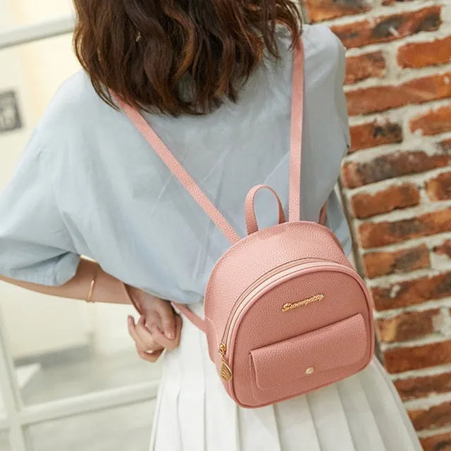 Black PU leather small women's backpack with zipper, shown as a shoulder bag