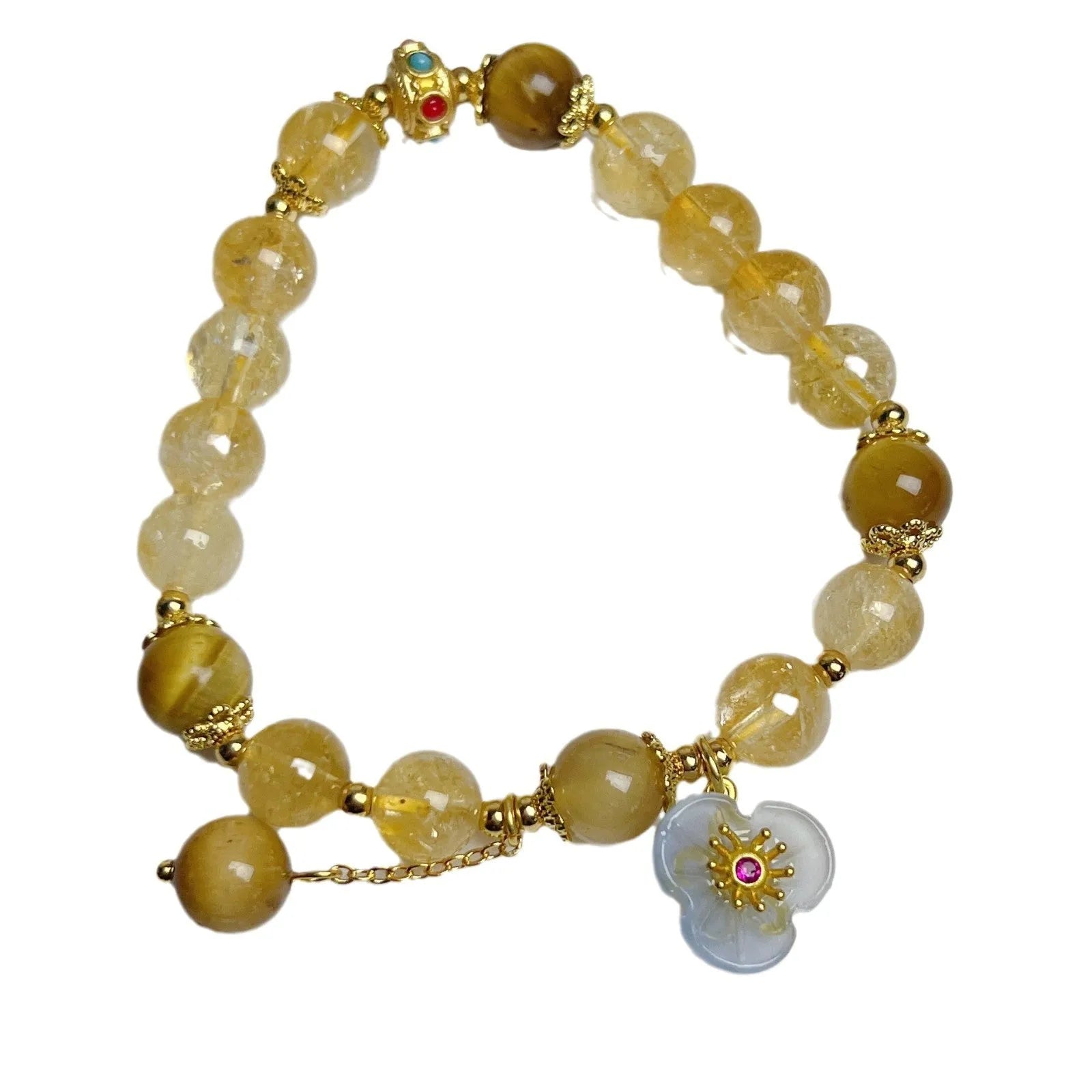 Women's handcrafted citrine crystal bracelet with flower tassel pendant on white background