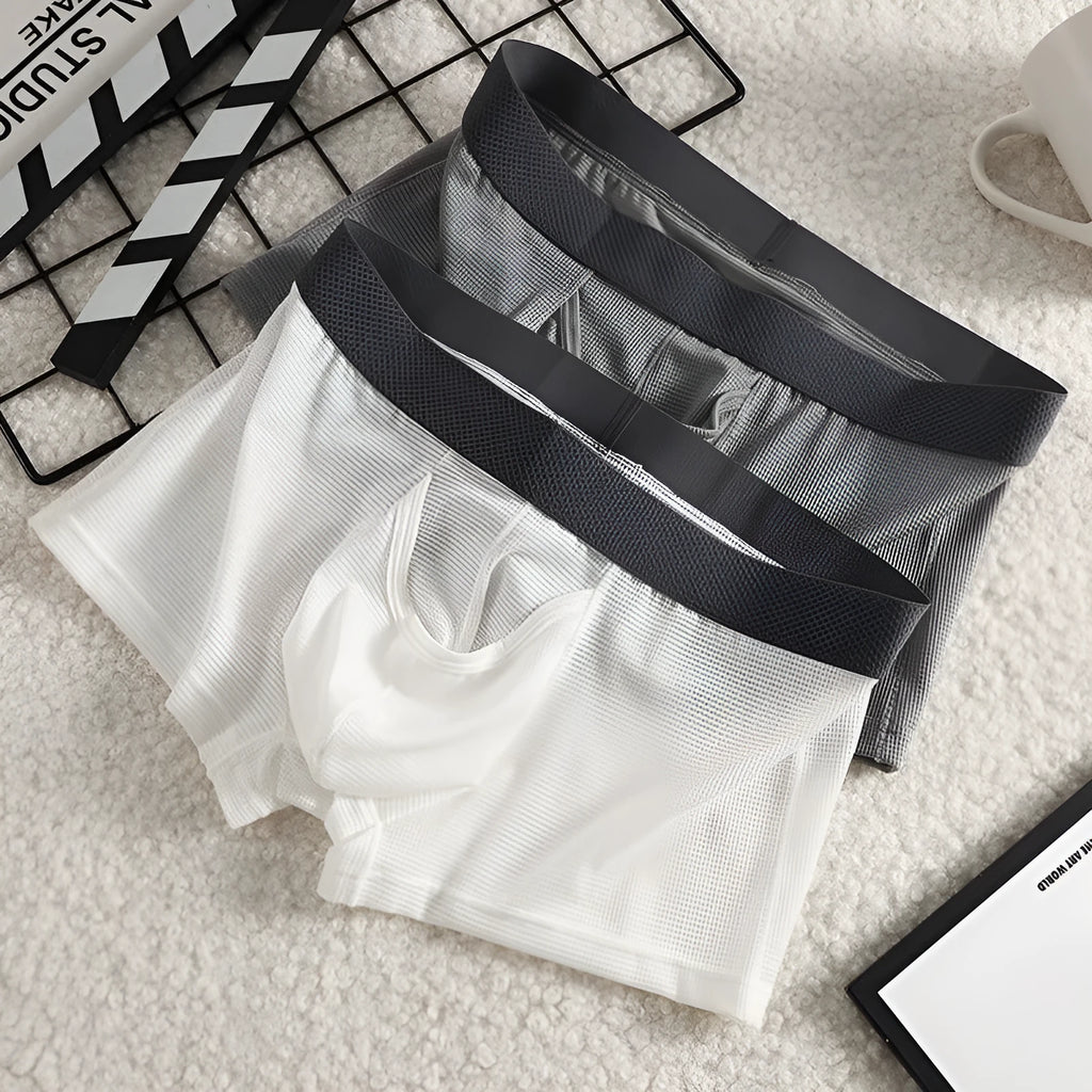 Men's ice silk boxer in black with mesh knit fabric, low waist, and solid colour design