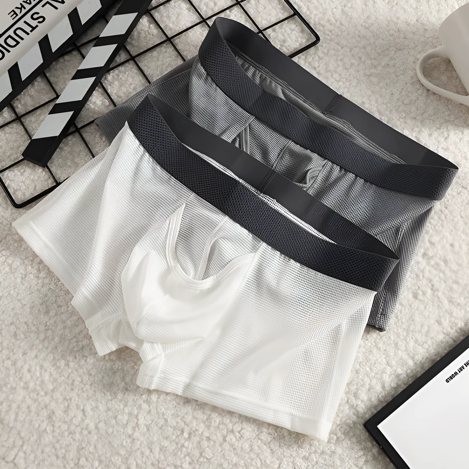 Men's ice silk boxer in black with mesh knit fabric, low waist, and solid colour design