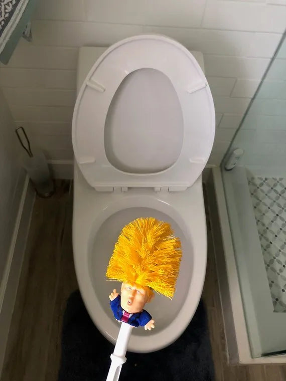 Yellow plastic Donald Trump toilet brush with handle slot, 40cm length, on white background