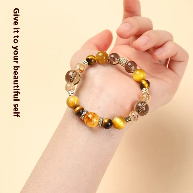 Natural tiger-eye crystal bracelet with geometric beads in either 10mm or 12mm size on a wrist.