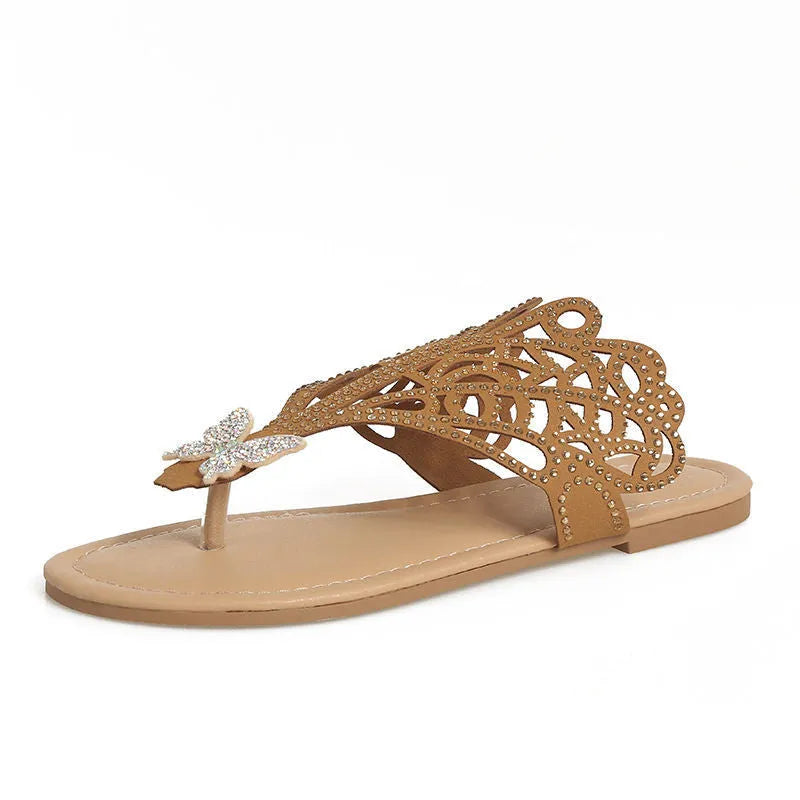 Women's black slip-on sandals with rhinestone accents and flip-toe design on flat rubber sole