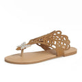 Women's black slip-on sandals with rhinestone accents and flip-toe design on flat rubber sole