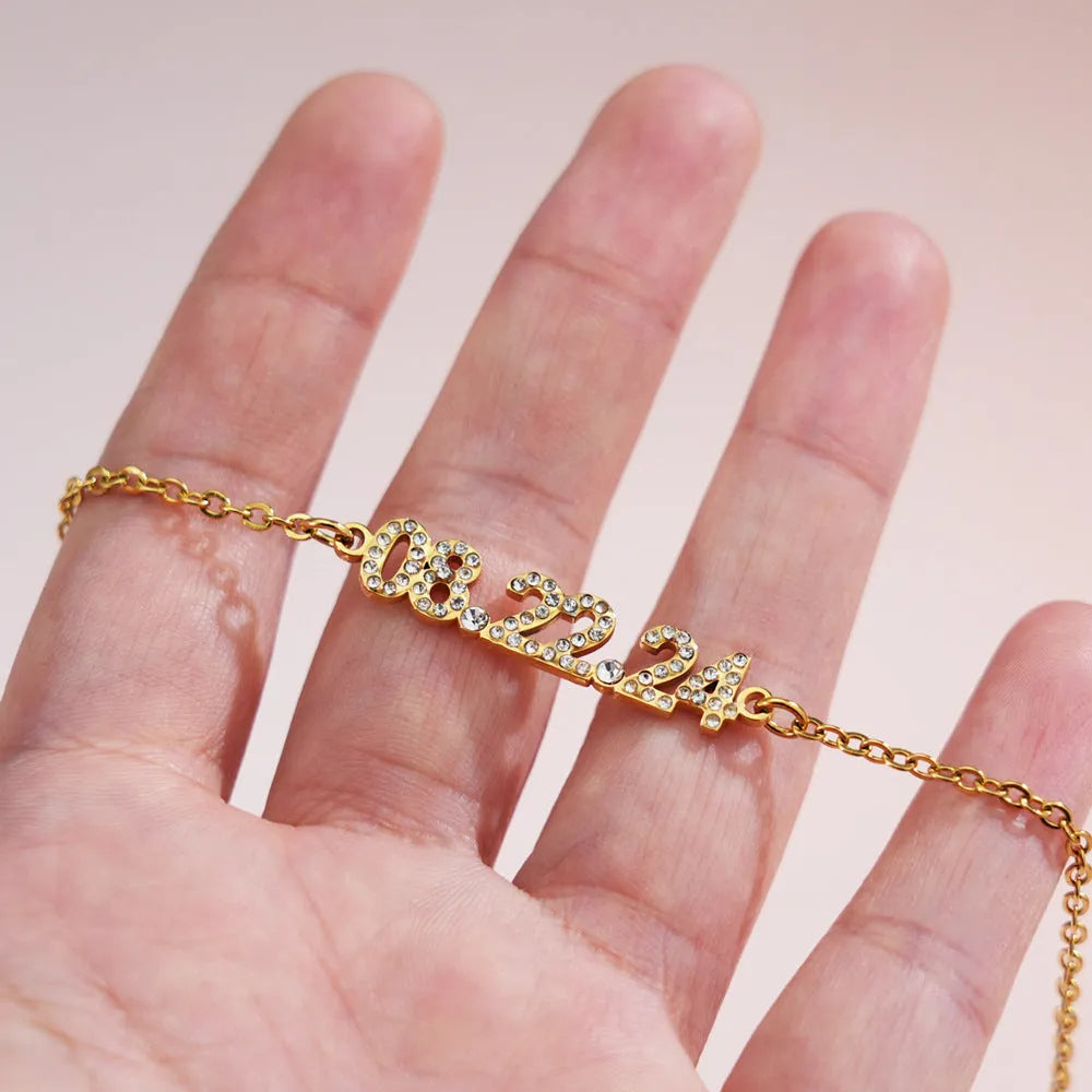 Stainless steel digital bracelet with diamond studded numbers, shown in gold, rose gold and steel colour options.