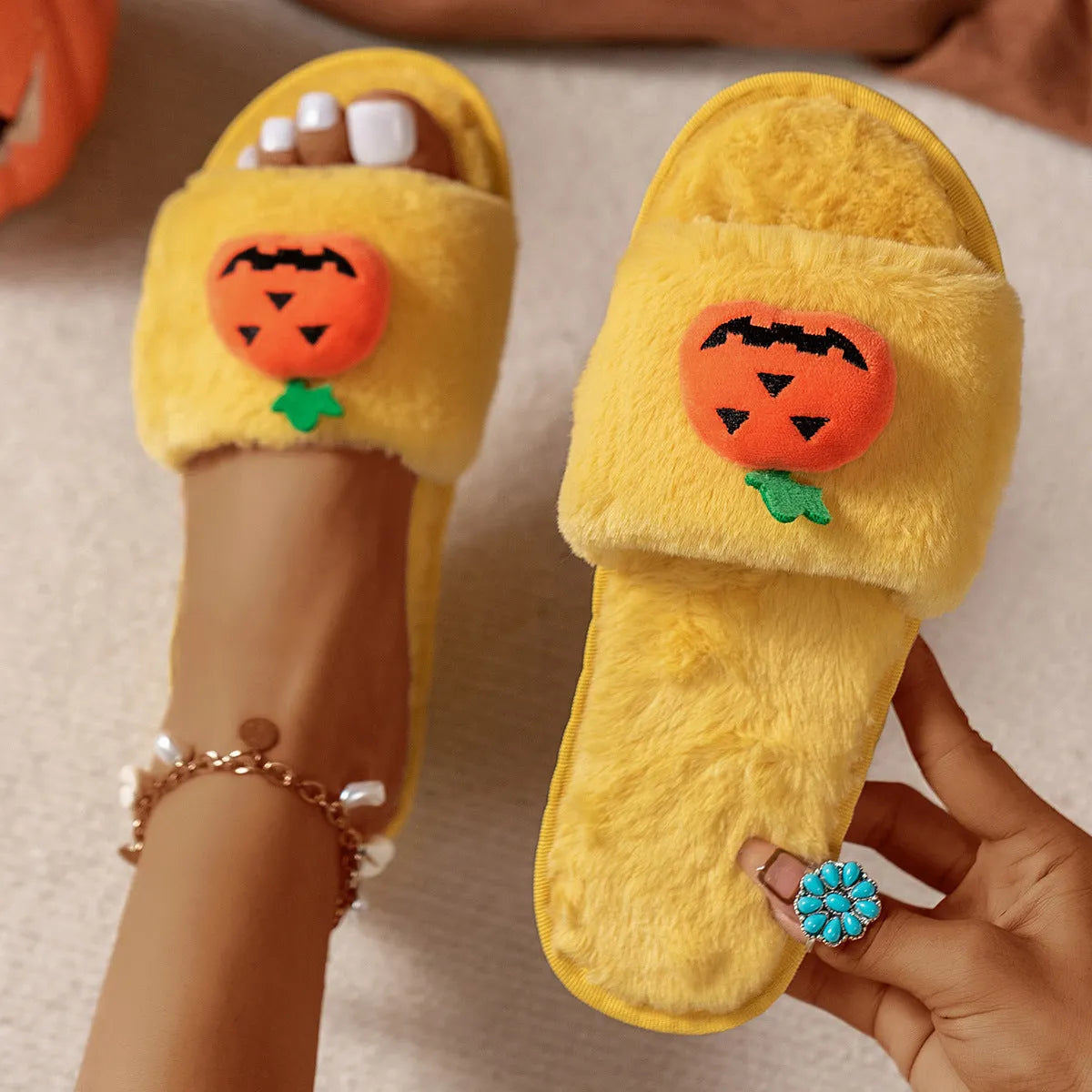 White and yellow Halloween pumpkin cartoon plush slippers with open toe and PVC sole.