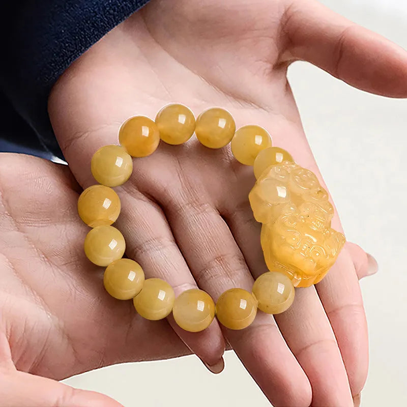 Carved golden thread jade money bracelet with traditional Chinese design showing detailed money motifs
