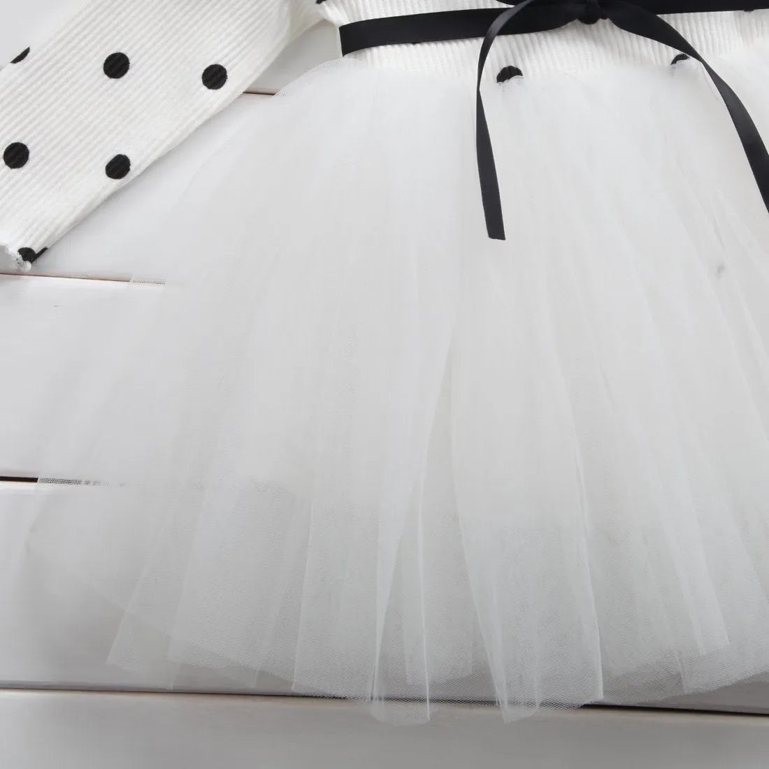 Baby girl wearing long sleeve lace tutu dress in pink for birthday party