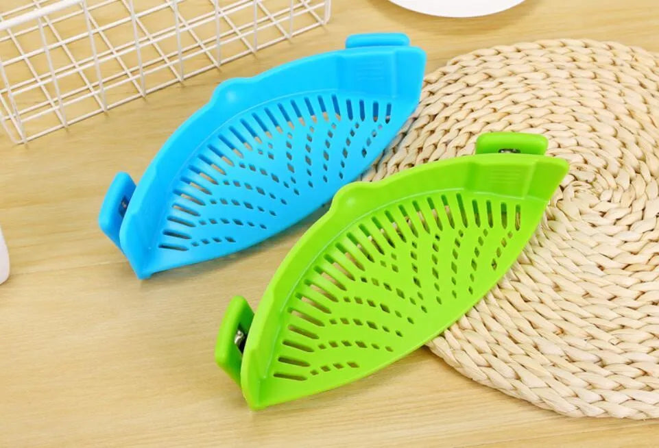Silicone clip-on pot strainer with uniform hollow design in Red, attached to a stainless steel pot rim