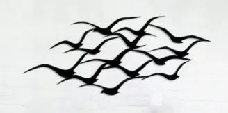 Metal flying bird wall decoration with seagull finish on a white wall