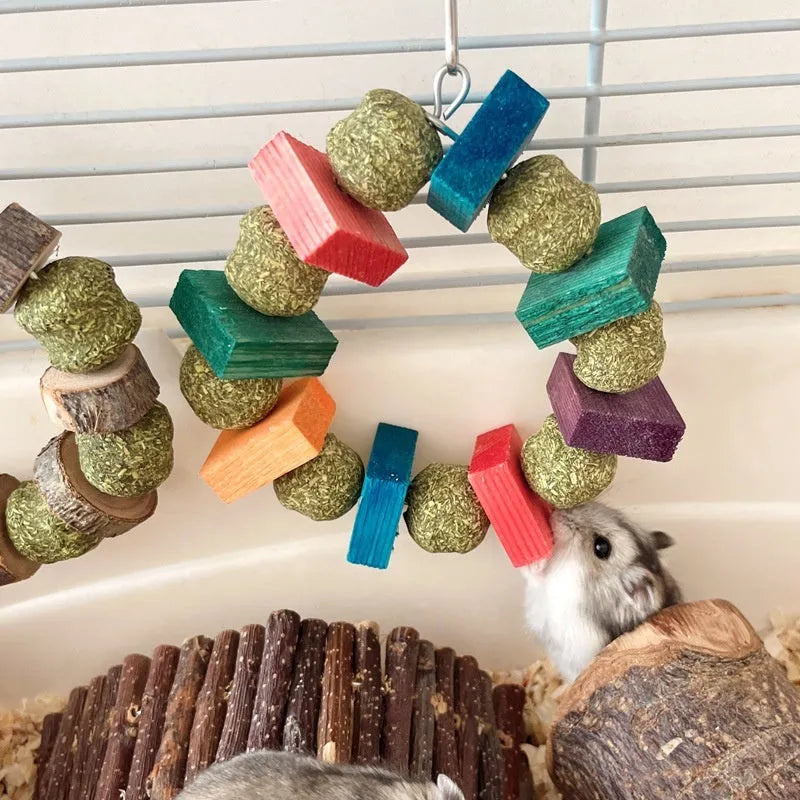 Natural applewood straw ball hamster chew toy with colourful sequin rings for guinea pigs and rabbits.