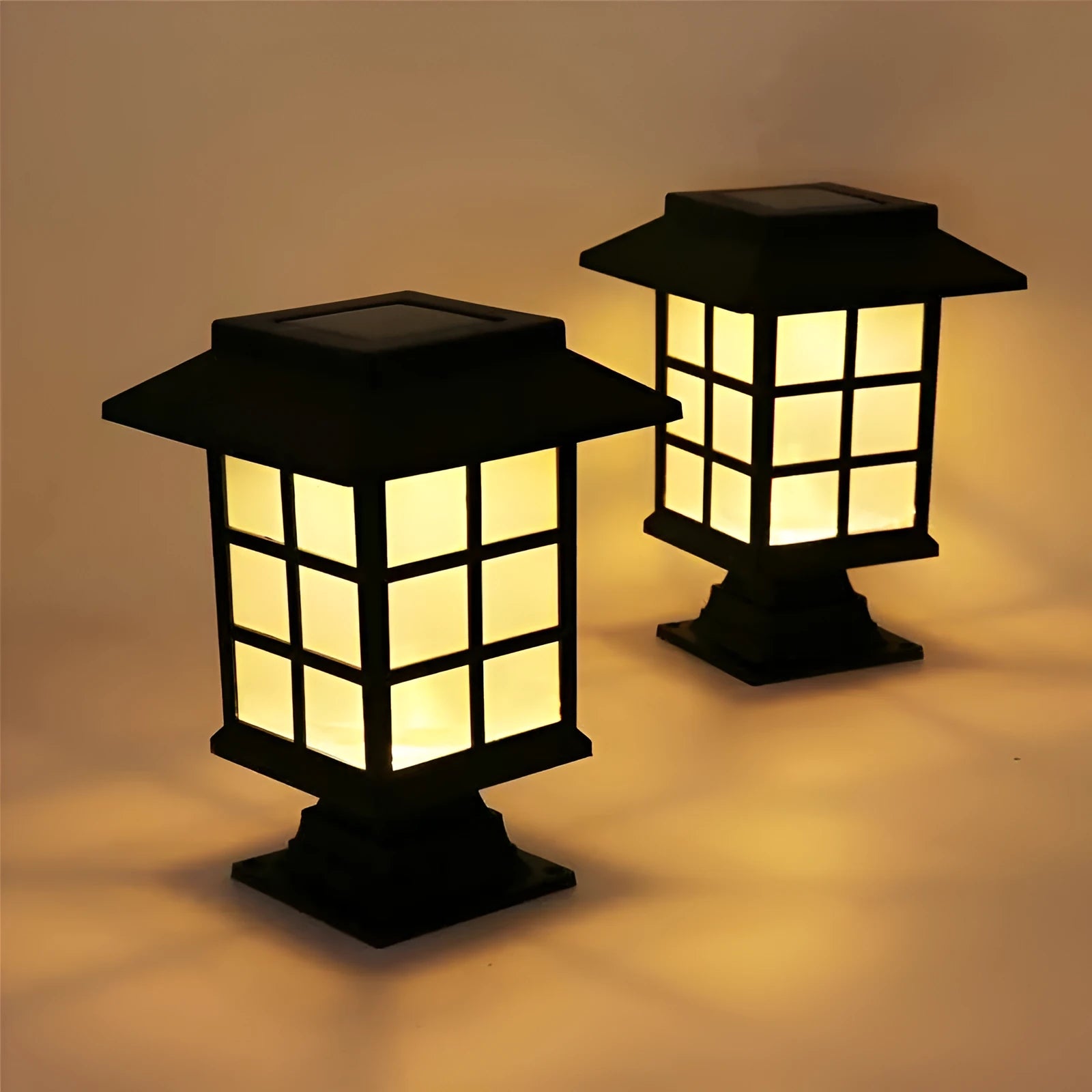 Solar outdoor LED lawn light with black body and white light through windows, set in a garden flower bed