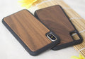 Wooden iPhone case with carbonised bamboo back and black TPU edges on a table.