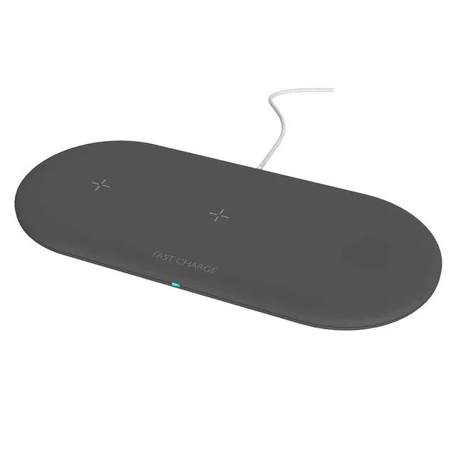 White three-in-one wireless charging station for Apple Watch, iPhone, and earbuds on a desk.