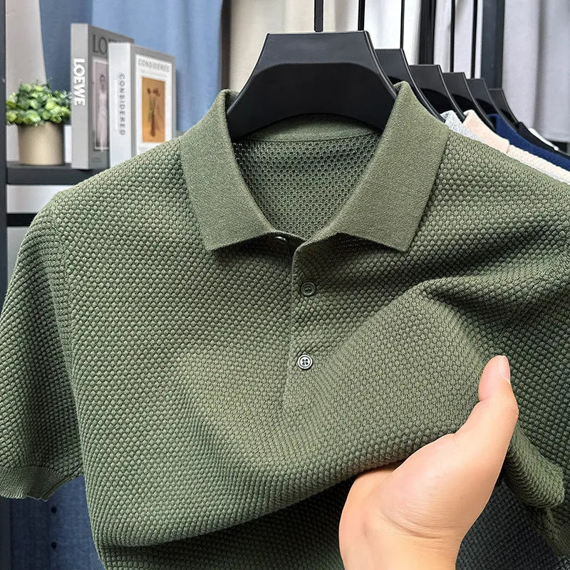 A loose short-sleeved cotton pullover sweater on a hanger, shown in a solid colour.