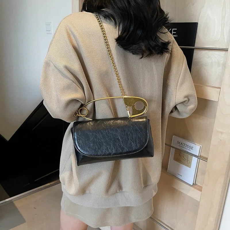 Creative paper clip shoulder handbag in PU leather with sewing thread detail, horizontal square shape