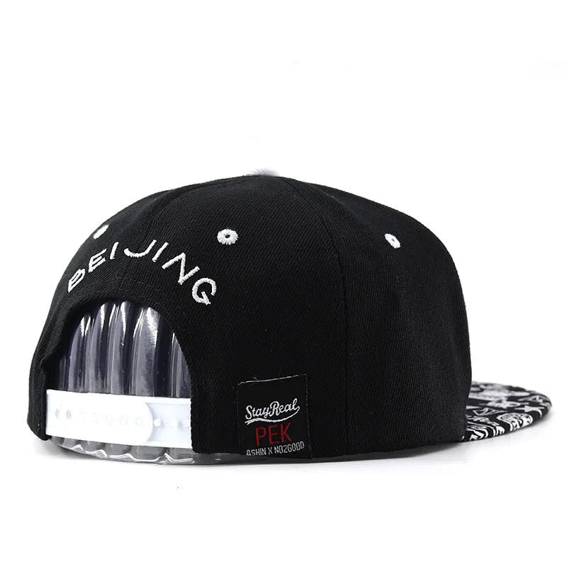 Cotton baseball cap with embroidered letters in black colour showing adjustable strap and dome crown