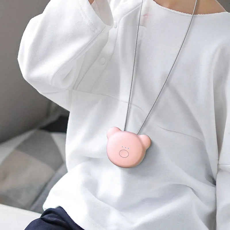 Mini USB rechargeable wearable air purifier necklace in pink, showing compact dimensions.