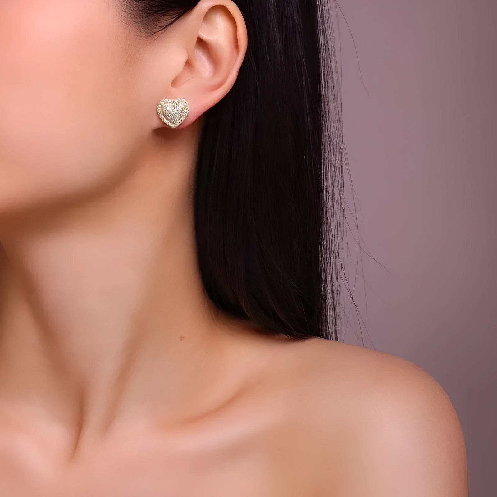 Gold-coloured heart-shaped moissanite stud earrings made from S925 silver on a plain background.