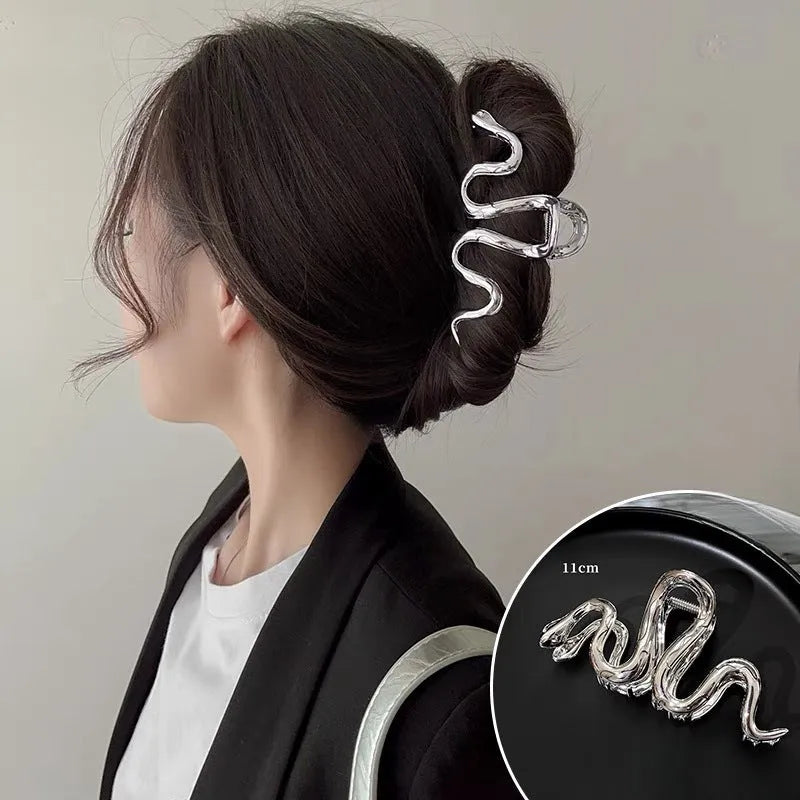 Slytherin serpentine metal hair clip in silver, 10.5cm, on flat surface