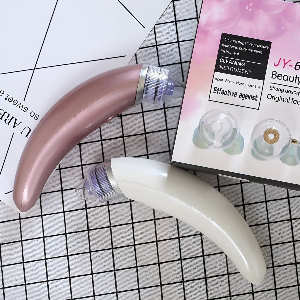 Electric blackhead suction instrument in rose gold or white for facial and nasal pore cleansing.