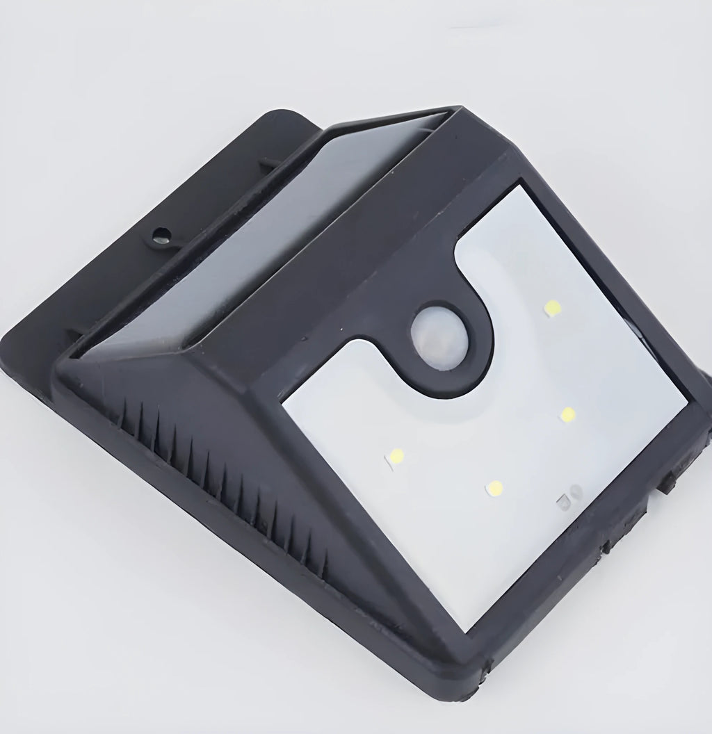 Set of four white solar-powered LED motion sensor lights for outdoor garden and security use.