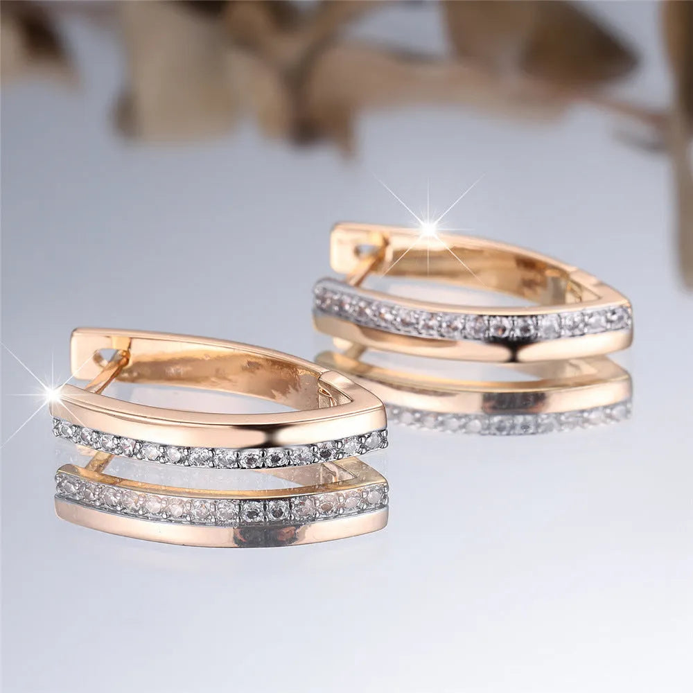 Women's V-shaped geometric copper ear clips in champagne gold with white diamond accents