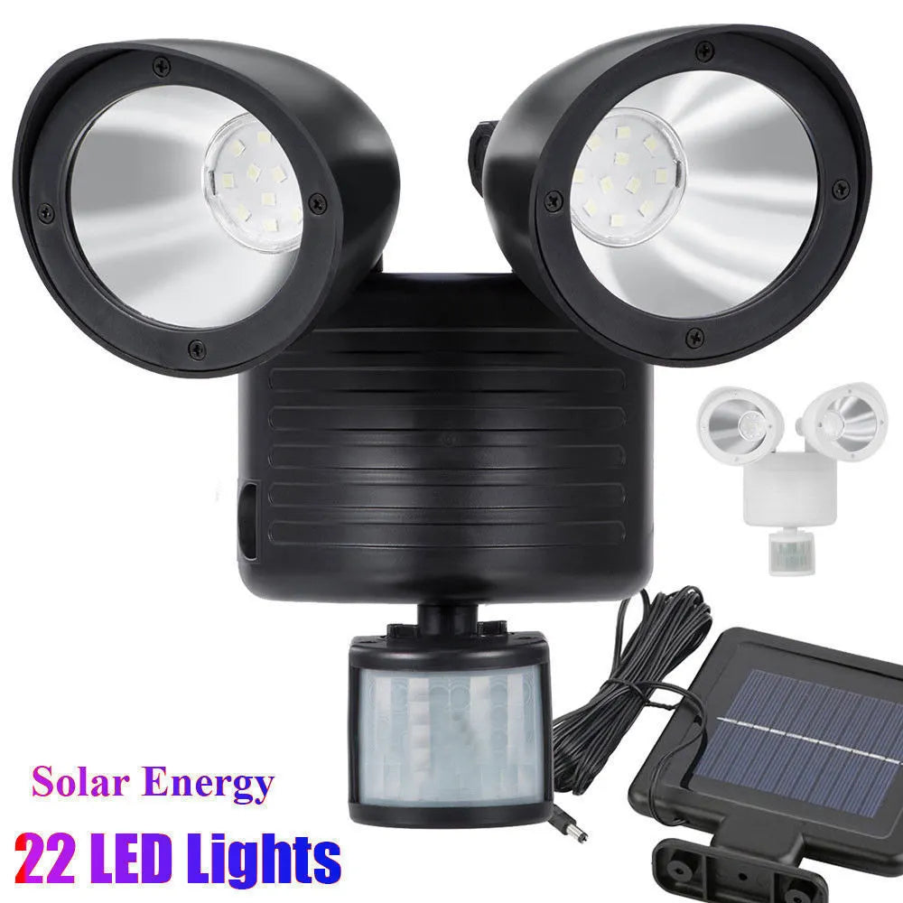 Double head solar induction spotlight in black mounted on a wall showing two LED panels