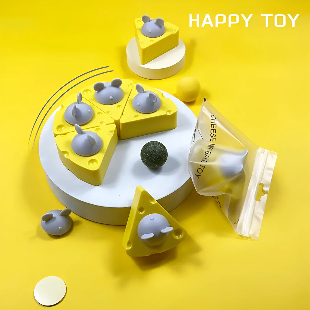 Yellow catnip and silvervine chew ball toy for cats on wooden floor