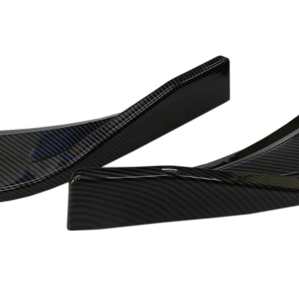 Audi A1 8X front splitter retrofit kit with three-section design in black Unksera pattern.