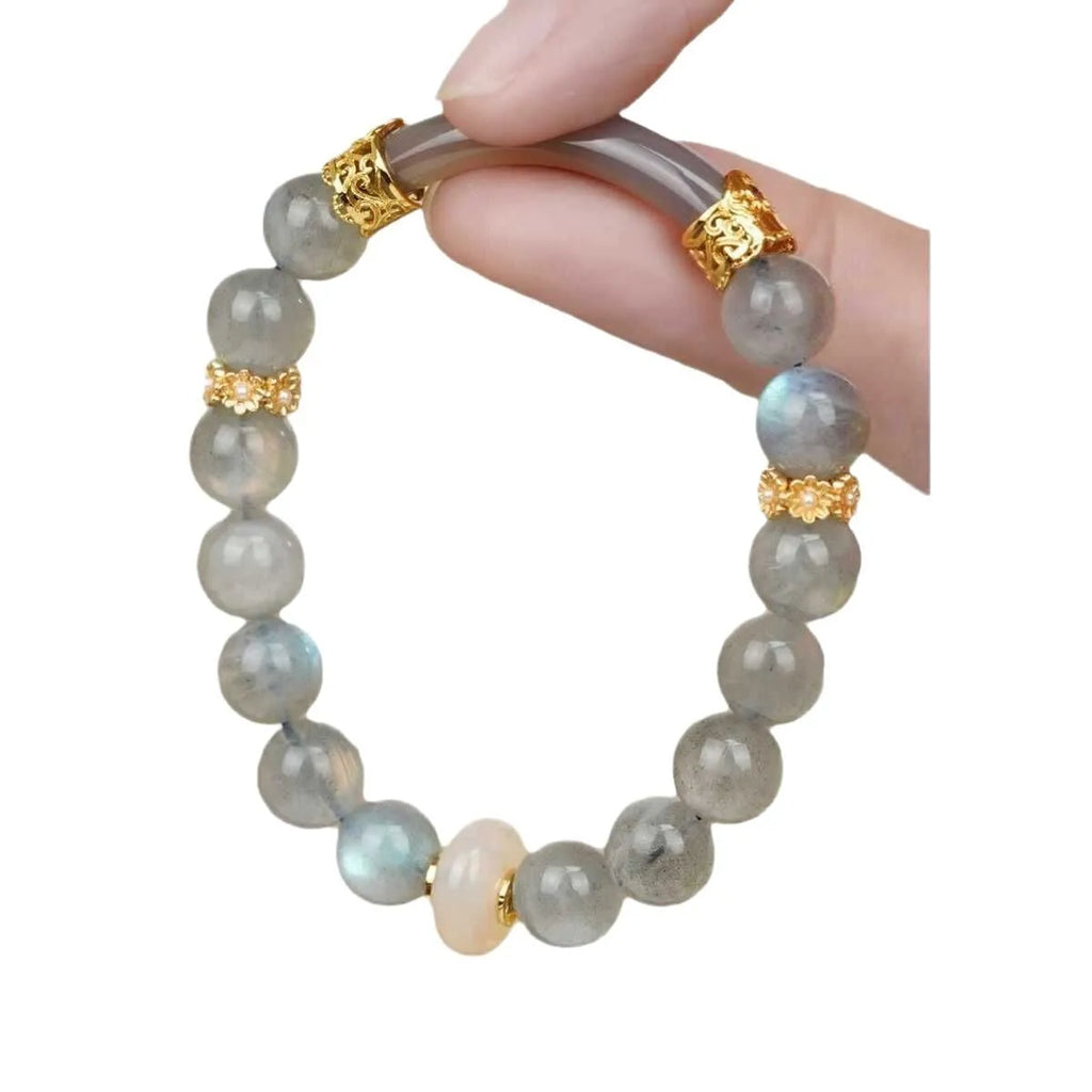 Gray moonstone agate half bracelet with round 8mm beads on a plain background
