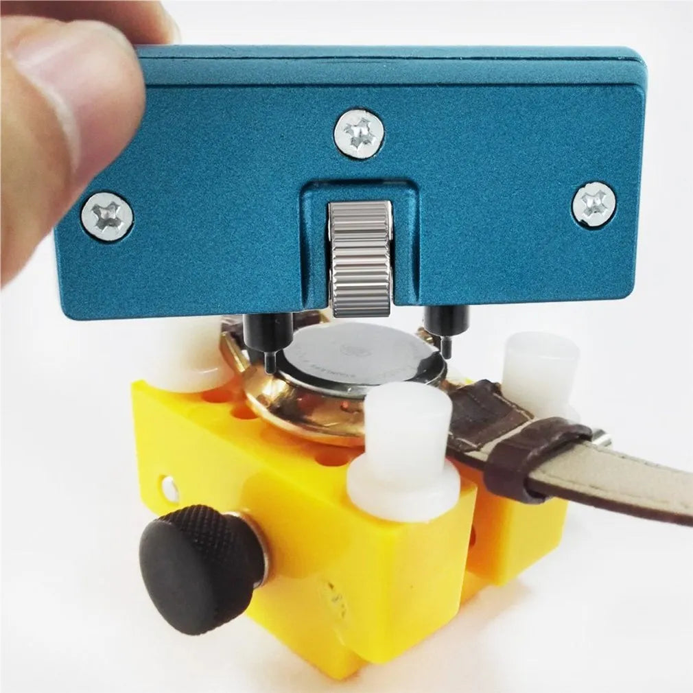 Yellow plastic watch repair case opener kit with mounting base and four fixing pillars on a workbench