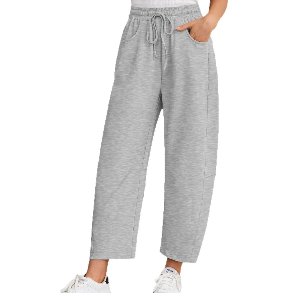Loose cropped sweatpants with elastic drawstring waist and pockets in street fashion styling
