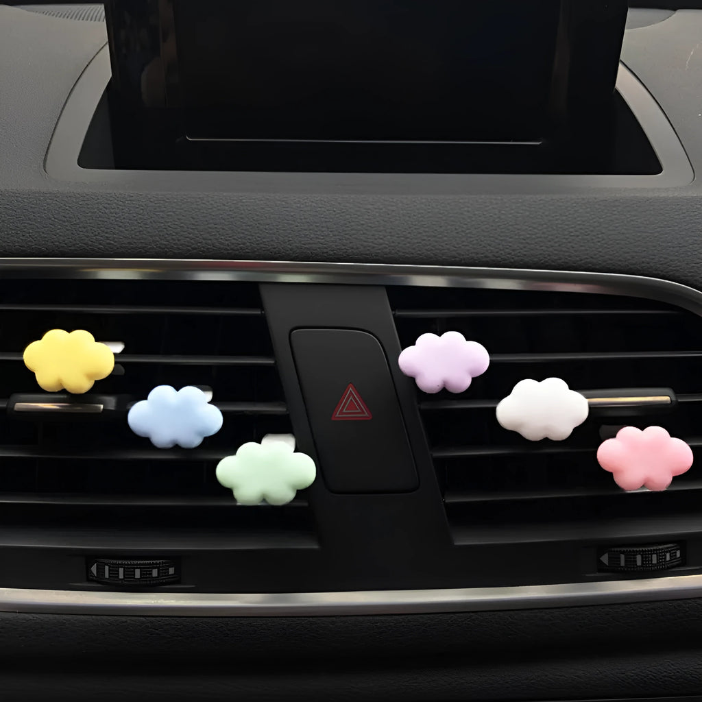 Resin cartoon car fragrance clip in one of six colours attached to vehicle air vent