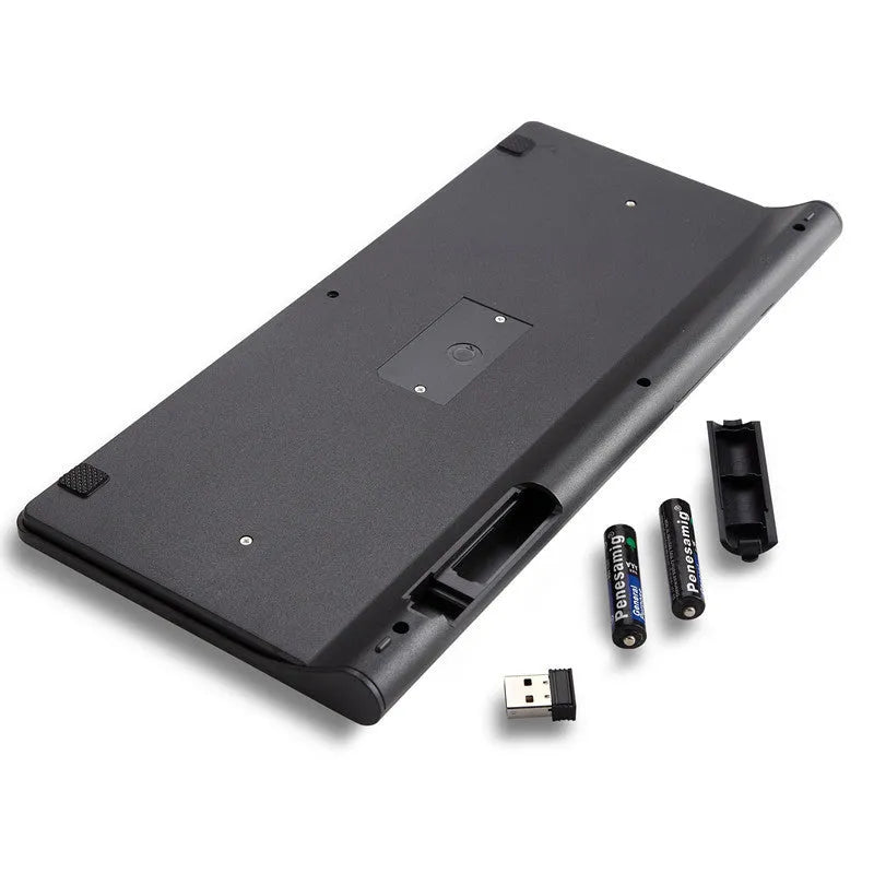 Black wireless keyboard and mouse set on wooden desk with USB receiver