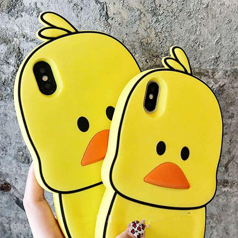 Green silicone iPhone case with a cartoon animal design on a table.