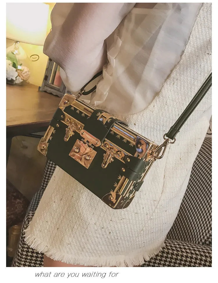 Women's hard black PU shoulder bag with flap, hasp closure, and rivet detail on a solid background.