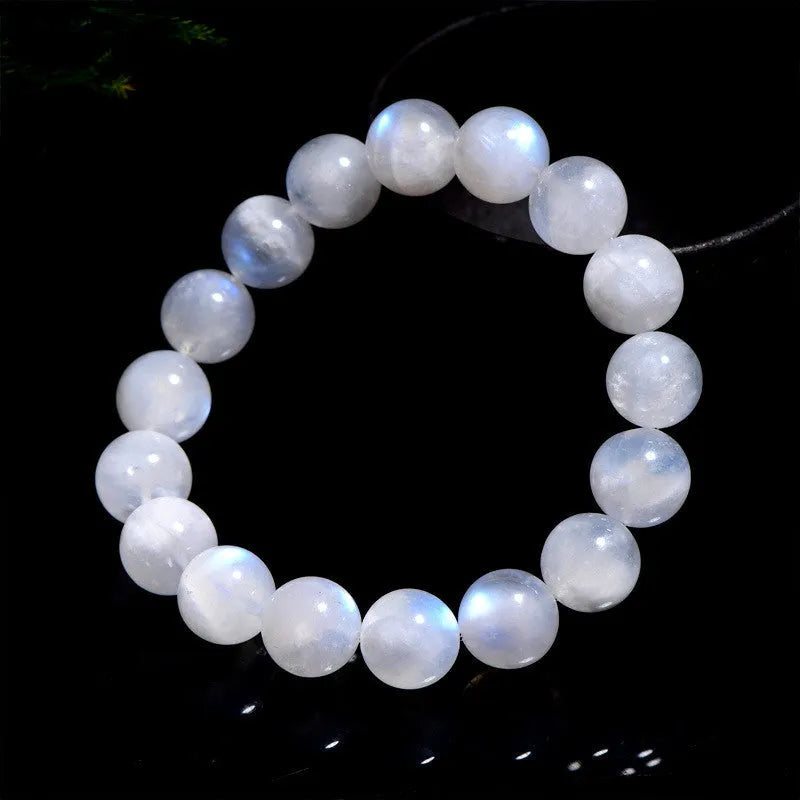 White polished moonstone bead bracelet with blue moonlight sheen, showing round geometric beads.