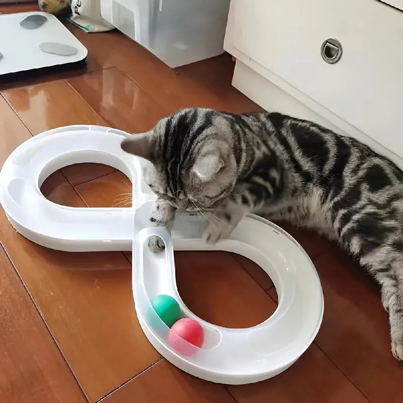 Blue cat turntable toy with rotating ball track and feather teaser wand on floor