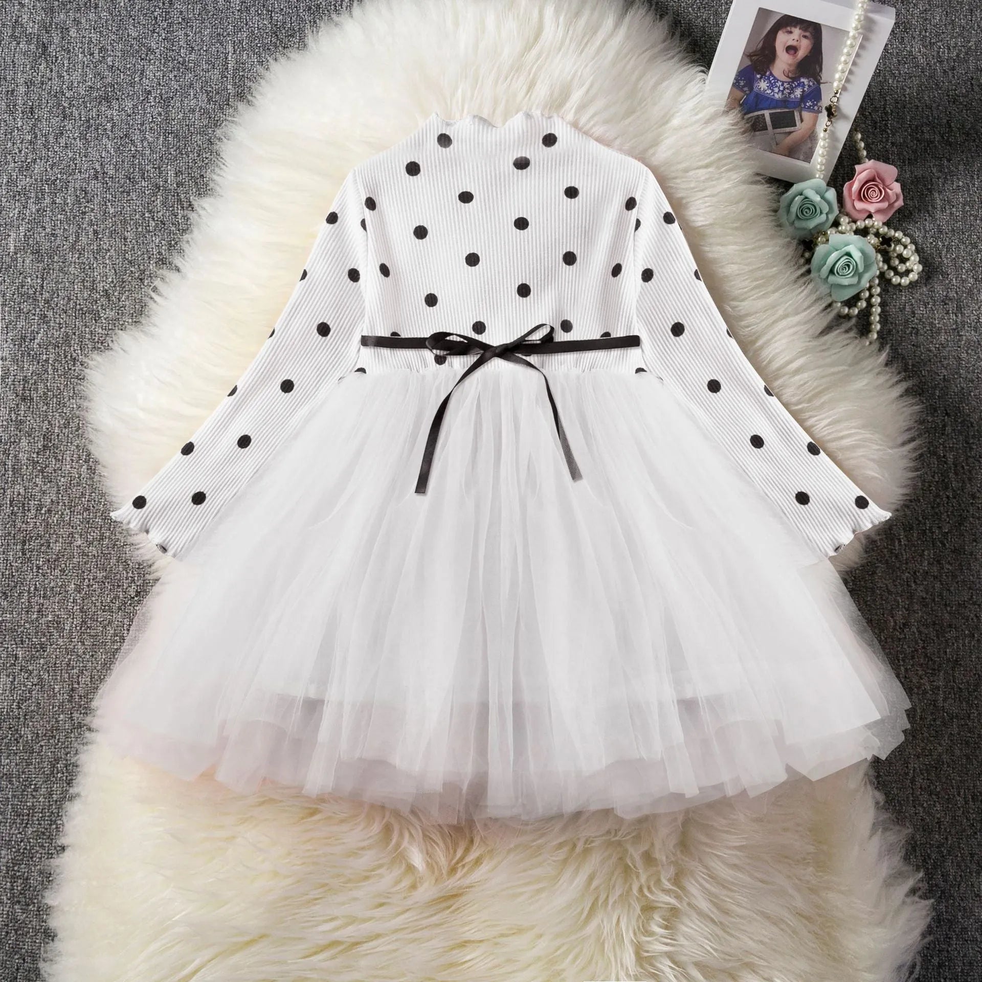 Baby girl wearing long sleeve lace tutu dress in pink for birthday party