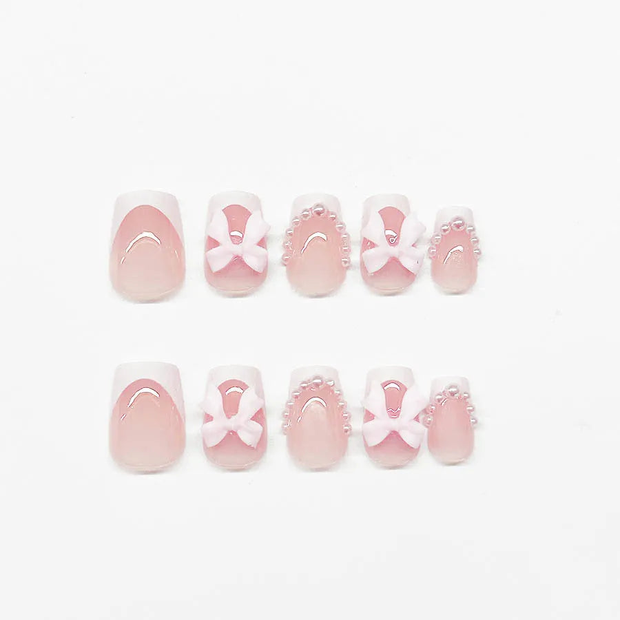 Set of short false nails with white French manicure, tulip, bow, starry sky, and leopard print designs.