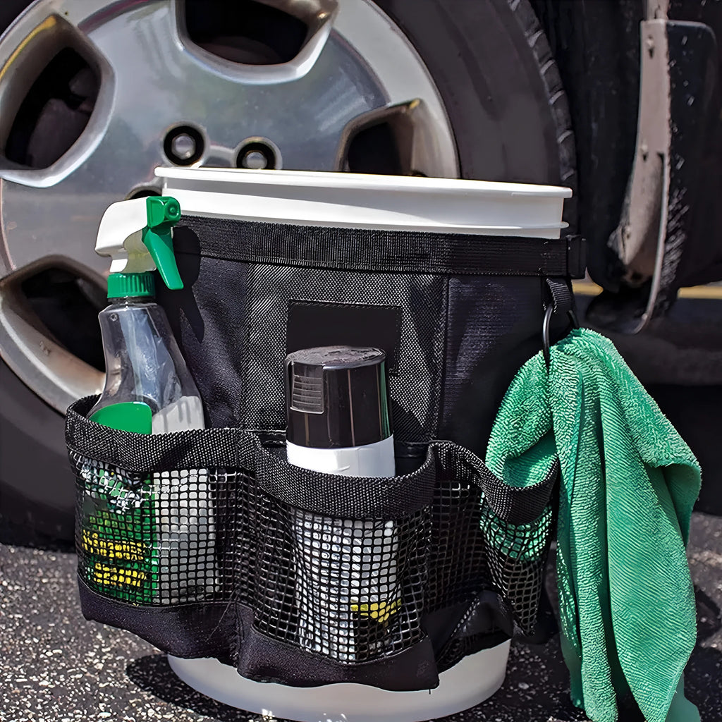 Black cylindrical polyester storage bag hanging on 5 gallon barrel with tools organised inside