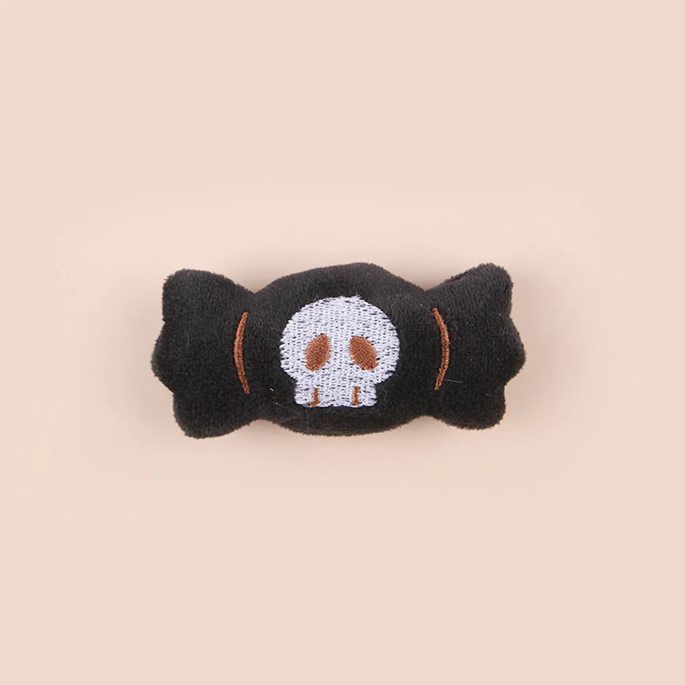 Small plush cat teaser wand with replaceable candy and skull head designs for interactive feline play