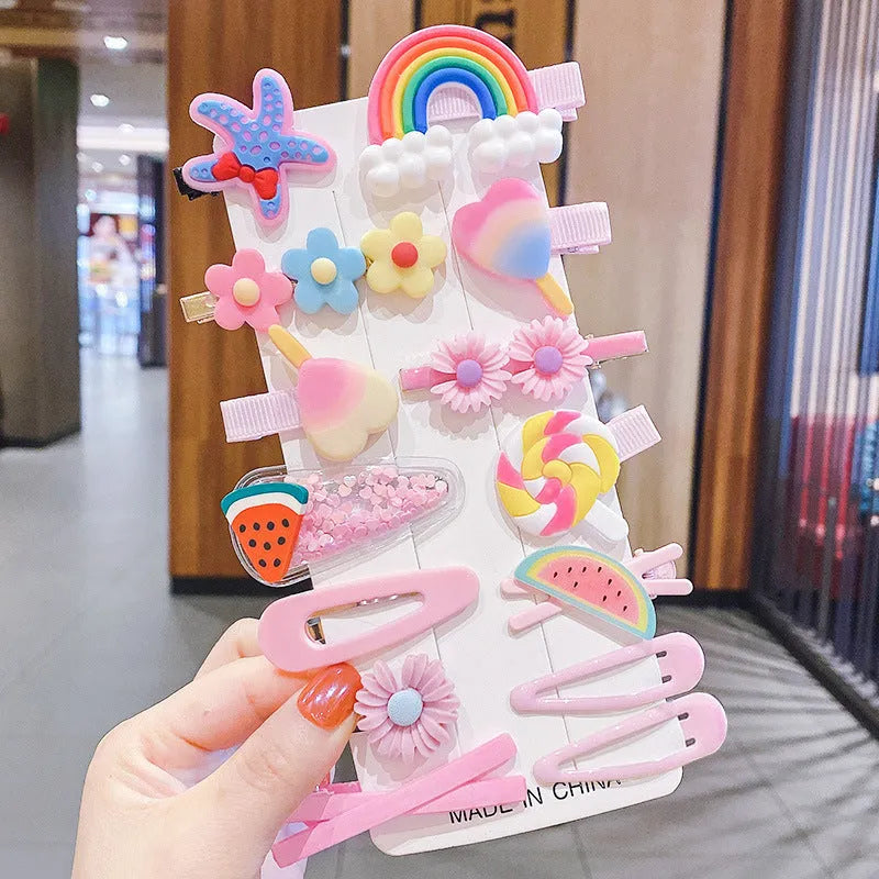 14-piece toddler hair accessories set on display including rainbow barrettes, fruit clips, and butterfly pins in bright colours