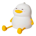 Chubby silicone night lamp on a desk showing phone holder and soft LED glow.