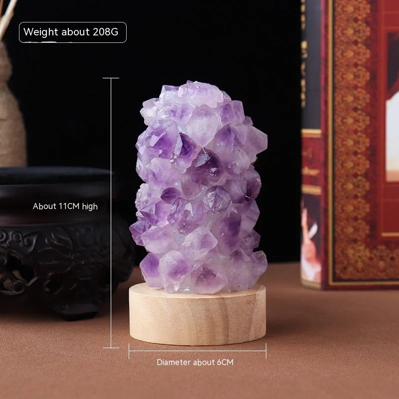 Natural amethyst vug tooth flower mini night light USB plug-in crystal lamp with warm light option on a wooden surface