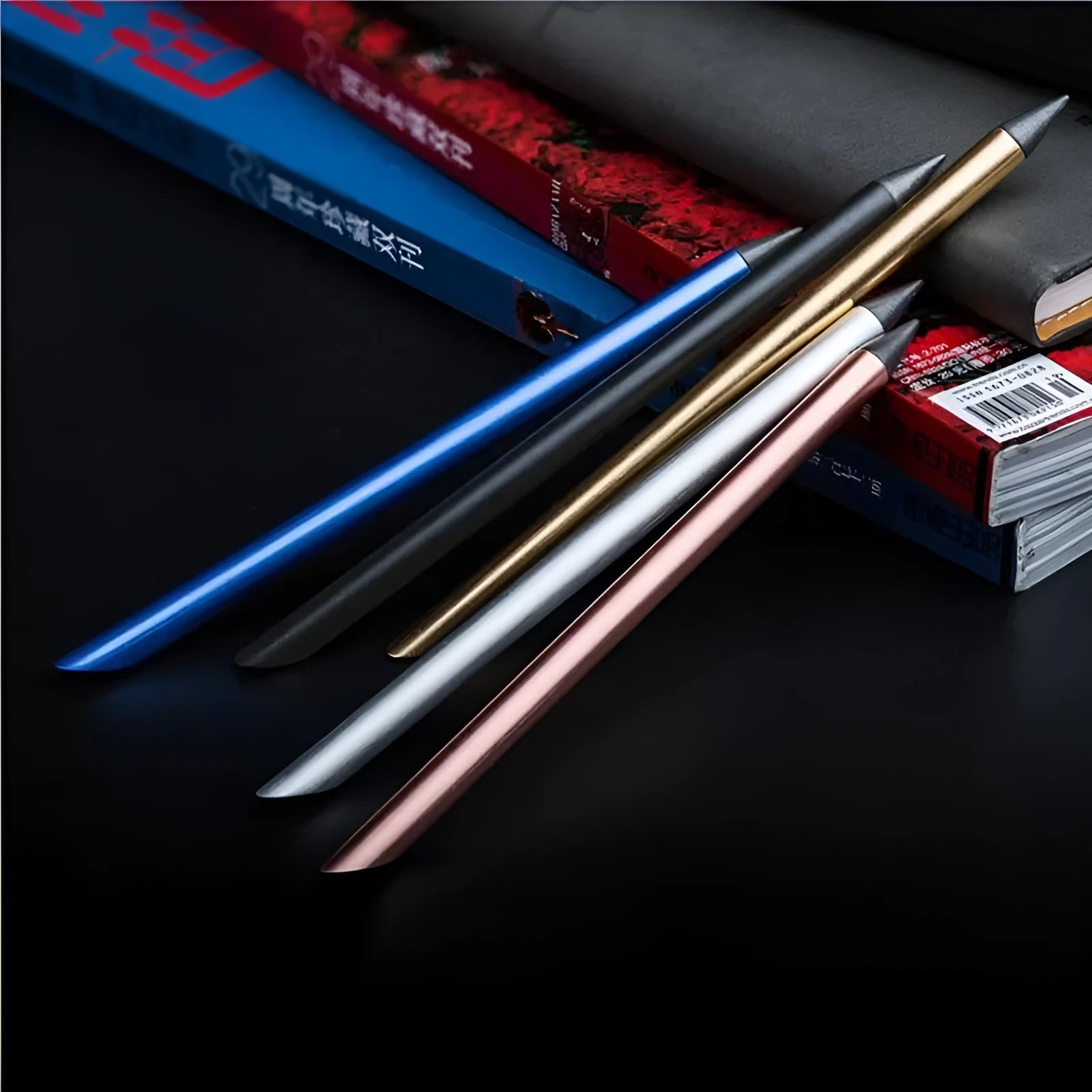 Silver inkless metal pen with 0.5mm alloy nib, spare nib, and fabric pen bag on a box.